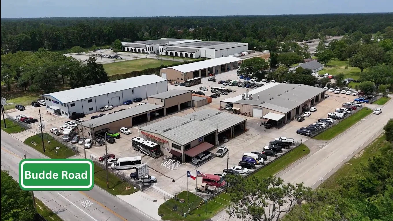 Aerial view of the Woodlands Car Care & Collision Center facility on Budde Road in The Woodlands, TX