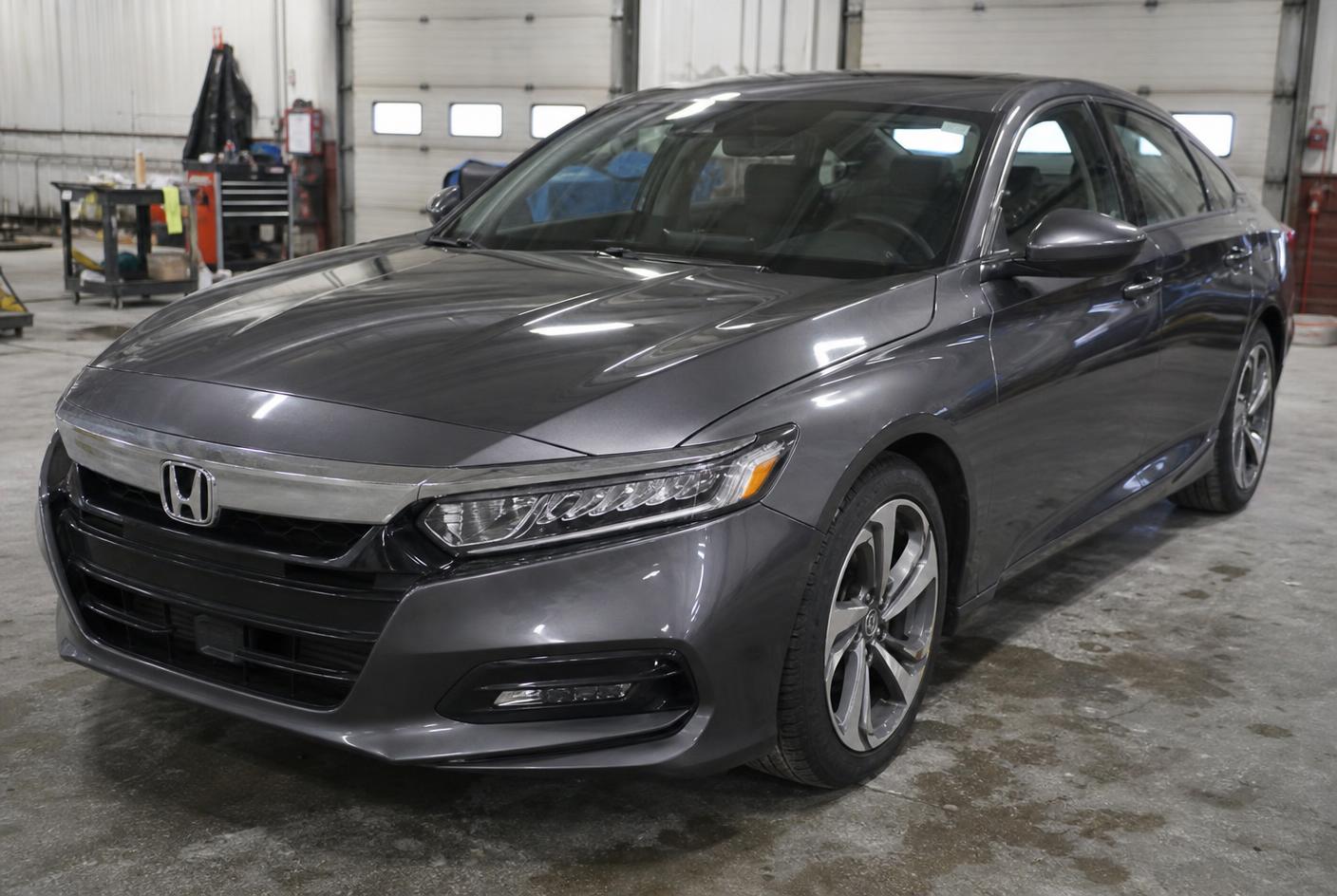 The same gray sedan after collision repair with straight panels and factory-matched paint