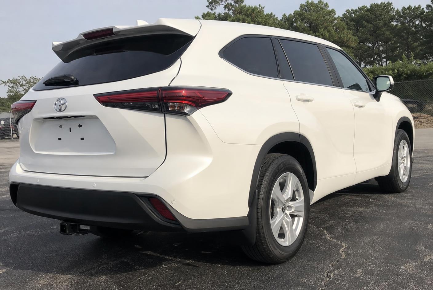 The same white SUV quarter panel after body work and seamless refinishing